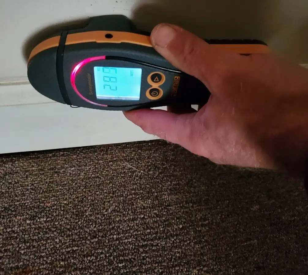 Moisture detection at baseboard during Storm Damage Restoration in Hampshire